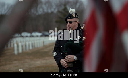 A bagpiper from the Eastern Long Island Police Pipes and Drums performs during the funderal service for Tech. Sgt. Dashan Briggs, a special missions aviation specialist assigned to the 106th Rescue Wing, New York Air National Guard, at Calverton National Cemetery, N.Y., March 29, 2018. Briggs was killed when the HH-60G Pave Hawk helicopter he was flying in crashed near the city of Al-Qa’im, Iraq. Stock Photo