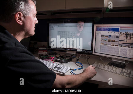 Charleston, S.C. (December 14, 2017) Space and Naval Warfare Systems Center (SSC) Atlantic employee Jason Staker conducts a cyber forensics examination on a computer hard drive. Staker works in the Digital Media Criminal Forensics Investigations Laboratory at SSC Atlantic. With its mission to help the Navy and other federal agencies recover data and solve criminal cases, the team offers unique operational cyber capabilities for the Navy and the nation. SSC Atlantic develops, acquires and provides life cycle support for command, control, communications, computer, intelligence, surveillance and  Stock Photo