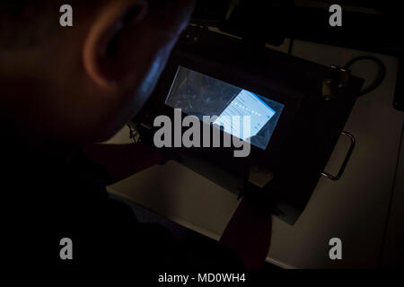Charleston, S.C. (December 14, 2017) Space and Naval Warfare Systems Center (SSC) Atlantic employee Jason Staker conducts a forensic triage on a cellular phone inside a Faraday enclosure. Staker works in the Digital Media Criminal Forensics Investigations Laboratory at SSC Atlantic. With its mission to help the Navy and other federal agencies recover data and solve criminal cases, the team offers unique operational cyber capabilities for the Navy and the nation. SSC Atlantic develops, acquires and provides life cycle support for command, control, communications, computer, intelligence, surveil Stock Photo