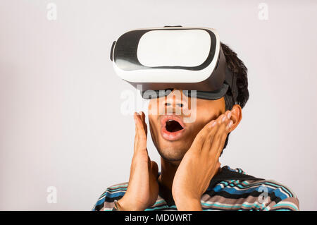 Excited young boy experiencing virtual reality headset Stock Photo