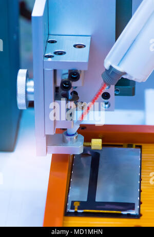 Robot holding glue syringe Injection Stock Photo