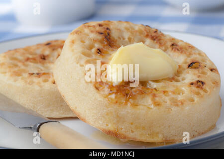 Hot Buttered Crumpets on a plate Stock Photo