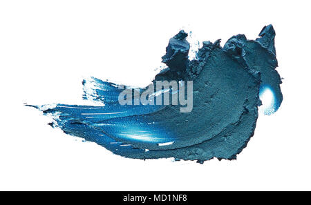 Navy blue creamy eye shadow isolated on white background. Texture of dark blue eye shadow on white. Smear of creamy eye shadow Stock Photo