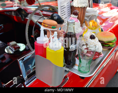 fake food on car window tray on side of red Chevrolet belair two door Stock Photo