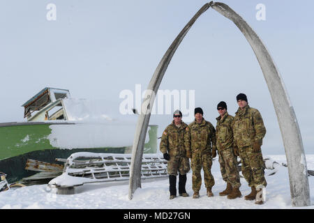 Maj. Gen. Mark O'Neil, left, commanding general, US Army Alaska, and his leadership team pose for a photo below a whale bone arch in Utqiaġvik, Alaska, March 14, as part of the U.S. Army Alaska-led Joint Force Land Component Command in support of Alaskan Command's exercise Arctic Edge 18 conducted under the authority of U.S. Northern Command. Arctic Edge 2018 is a biennial, large-scale, joint-training exercise that prepares and tests the U.S. military's ability to operate tactically in the extreme cold-weather conditions found in Arctic environments. (U.S. Air Force photo by Capt. Virginia Lan Stock Photo