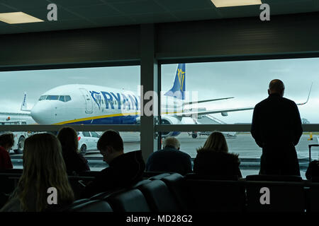 Passengers wait to board a plane at Bristol Airport. Stock Photo