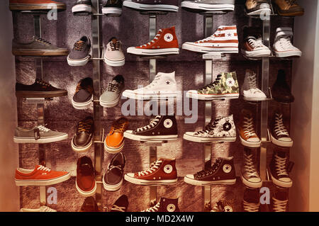 Converse trainers and Vans shoes on display Stock Photo