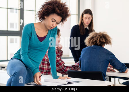 Young dedicated student reviewing an essay during break Stock Photo