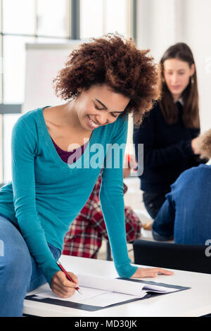Young dedicated student reviewing an essay during break Stock Photo