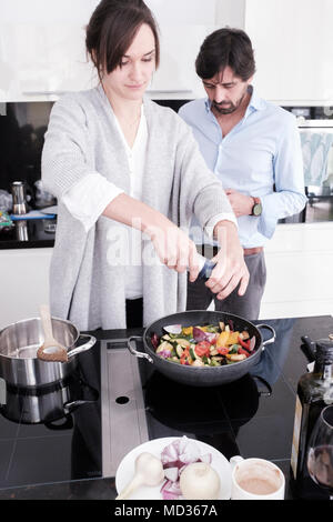 Couple cooking together Stock Photo