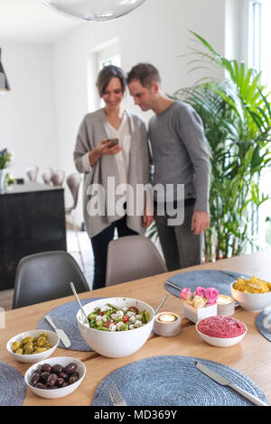 Couple taking a picture of their vegetarian meal to share on social media-selective focus Stock Photo
