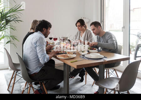 Sunday Lunch-Vegetarian food.Group of vegan friends having lunch together Stock Photo