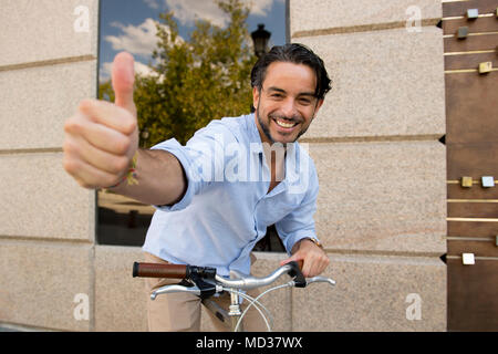 young happy attractive hispanic man in casual trendy clothes smiling cheerful posing cool with vintage cool retro bicycle in modern stylish lifestyle  Stock Photo