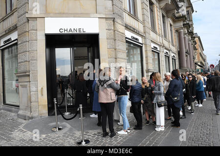 Copenhagen, Denmark. 18th Apr, 2018. French chain Chanel opens its first shop ever in Copenhagen first consumer with Chanel shopping bag and consumer waiting outside in line at chanel shop to shopping today on its first day of Chanel business in Copenhagen Denmaerk..       (Photo.Francis Joseph  Dean / Deanpictures. Credit: Francis Joseph Dean / Deanpictures/Alamy Live News