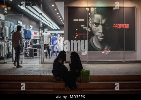 Riyadh, Saudi Arabia. 09th Feb, 2018. A picture made available on 18 April 2018 shows a Saudi Arabian women sitting outside a sports clothing store on a commercial street in Riyadh, Saudi Arabia, 09 February 2018. (to go with dpa-story about Saudi-Arabia in English text service) Credit: Oliver Weiken/dpa/Alamy Live News Stock Photo