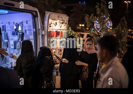 Riyadh, Saudi Arabia. 09th Feb, 2018. A picture made available on 18 April 2018 shows a Saudi Arabian women at a vendor selling cellphone accessories on a commercial street in Riyadh, Saudi Arabia, 09 February 2018. (to go with dpa-story about Saudi-Arabia in English text service) Credit: Oliver Weiken/dpa/Alamy Live News Stock Photo