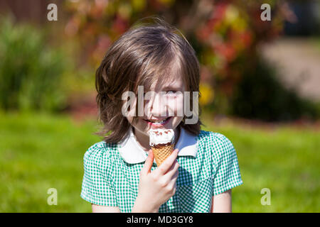 Ashford, Kent, UK. 18th Apr, 2018. UK Weather: A very hot day in Ashford, Kent this afternoon with temperatures expected to exceed 25°C in some parts of the country. Takara, an 8 year old girl enjoys an ice cream after just finishing school for the day. © Paul Lawrenson 2018, Photo Credit: PAL Images / Alamy Live News Stock Photo