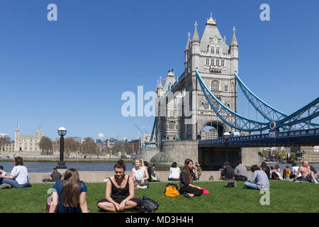 London, UK. 18th Apr, 2018.  People enjoying the sunshine alongside the River Thames, with Tower Bridge in the background, on one of the hottest days of the year so far.  The warm weather is forecasted to last for the rest of the week.  Credit: Milton Cogheil/Alamy Live News Stock Photo