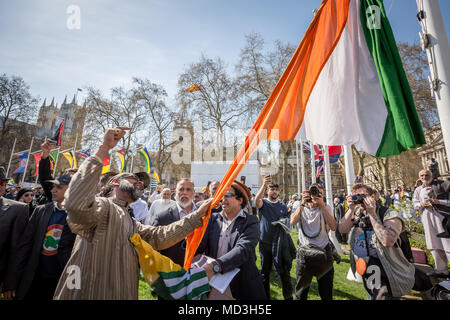 London, UK. 18th April, 2018. Anti-Modi Kashmiri protesters tear down the Indian flag flying with other commonwealth flags in Parliament Square during the organised mass protests against Narendra Modi, the President of India visting the UK and meeting with PM Theresa May at Downing Street. © Guy Corbishley/Alamy Live News Stock Photo