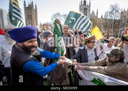 London, UK. 18th April, 2018. Anti-Modi Sikh and Kashmiri protesters tear down the Indian flag flying with other commonwealth flags in Parliament Square during the organised mass protests against Narendra Modi, the President of India visting the UK and meeting with PM Theresa May at Downing Street. © Guy Corbishley/Alamy Live News Stock Photo