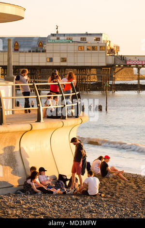 Aberystwyth Wales UK, Wednesday  18 April 2018  People enjoying the sunset  in Aberystwyth  at the end of a day of gloriously warm spring sunshine, as temperatures across the UK start to soar into the high 20’s centigrade, making it the warmest April weather for many years.   photo © Keith Morris  / Alamy Live News Stock Photo