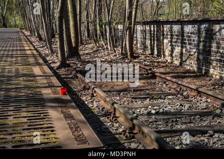 Berlin, Germany. 18th Apr, 2018. Wednesday, April 18, 2018.An unlit candle is placed on a plaque at the Gleis 17 (Track 17) Memorial at Grunewald Station in Berlin, Germany. Track 17 at the Grunewald Station was one of the major sites of deportation of the Berlin Jews during World War II. Prior to 1942, the trains from this site left mainly for the ghettos of Litzmannstadt and Warsaw. But from 1942, the trains went directly to concentration camps including Auschwitz and Thereisienstadt.Plaques with details of every deportation shipment of Jews from Berlin exist on both sides of the platf Stock Photo