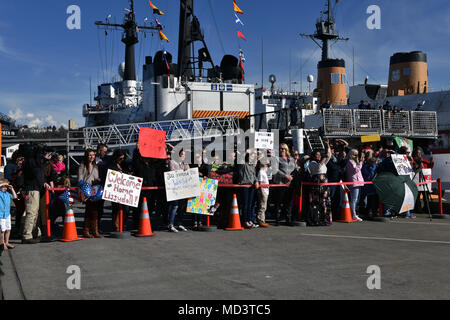 Friends and family members wait for the crew of the Coast Guard Cutter Polar Star, a 399-foot heavy icebreaker, while the vessel is moored at Base Seattle, March 16, 2018. The Polar Star crew departed Seattle on November 30th to assist in the annual delivery of operating supplies and fuel for NSF research stations in Antarctica. U.S. Coast Guard photo by Petty Officer 2nd Class Ali Flockerzi. Stock Photo