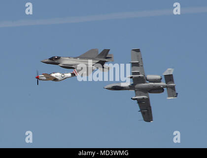 The Heritage Flight, comprising of the P-51 Mustang, F-35 Lightning II and A-10 Thunderbolt, breaks off at the end of its performance during Luke Days at Luke Air Force Base, Ariz., March 17, 2018. Luke Days demonstrates the capabilities of modern military and civilian airpower through the display of more than 30 live air and ground demonstrations and static exhibits. (U.S. Air Force photo by Senior Airman James Hensley) Stock Photo