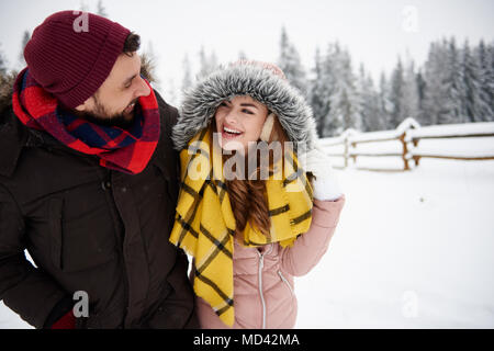 Young couple walking in snow Stock Photo