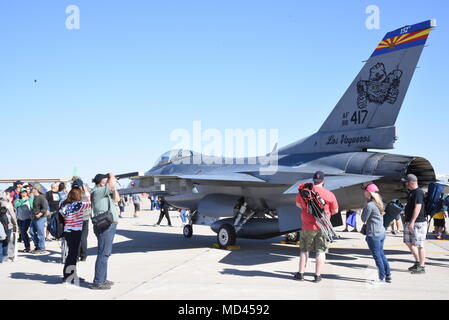 Onlookers gather to observe the F-16 Fighting Falcon from Tucson, Arizona and talk to readily available pilots, to learn more about the lethality and aerodynamic capabilities of the aircraft here during the Luke Days Air Show, March 17, 2018. The wing has trained pilots from 25 countries that fly the F-16 today while developing strategic partnerships and building strong international relationships based on performance, friendship, and trust. (U.S. Air National Guard photo by 1st Lt. Tinashe Machona) Stock Photo