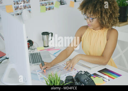 Confident woman working with photos Stock Photo