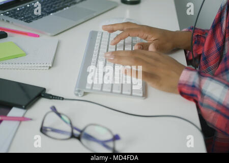Crop worker typing on keyboard Stock Photo