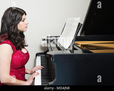 A woman playing a piano Stock Photo