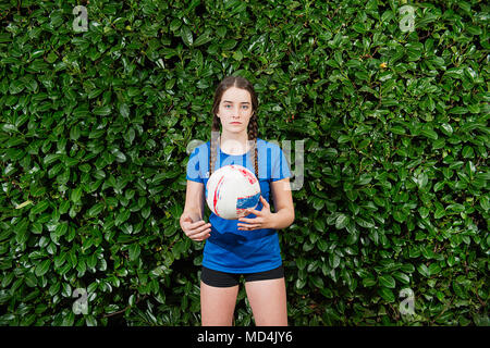 A teenaged girl (13 years old) holding a volleyball. Stock Photo