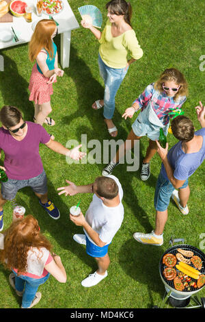 Friends talk to each other while spending their free time in the fresh air in the vacations Stock Photo