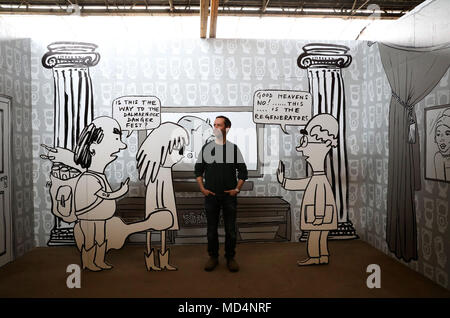 Artist Mick Peter stands in a room which is a view behind 'Regenerators' which is an 80-metre long billboard piece in Glasgow which covers the empty facade of an historic former gas purifying shed which is part of the Glasgow International Festival of Visual Art. Stock Photo