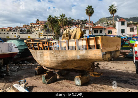 Camara de Lobos, Madeira, Portugal - December 10, 2016: Wooden fishing boat on the shore of fishing village Camara de Lobos near Funchal, Madeira Isla Stock Photo