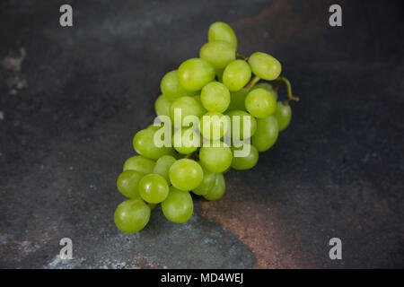 Bunch of Grapes on a grey background flatlay style, bunch of green grapes Stock Photo
