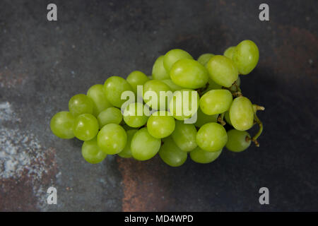 Bunch of Grapes on a grey background flatlay style, bunch of green grapes Stock Photo