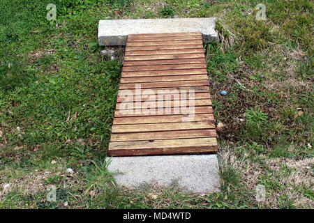 Makeshift wooden bridge over water Stock Photo - Alamy