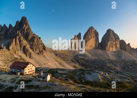 Tre Cime di Lavaredo and Drei Zinnen hut at sunset, Tre Cime Natural Park, Dolomites, South Tyrol, Italy Stock Photo