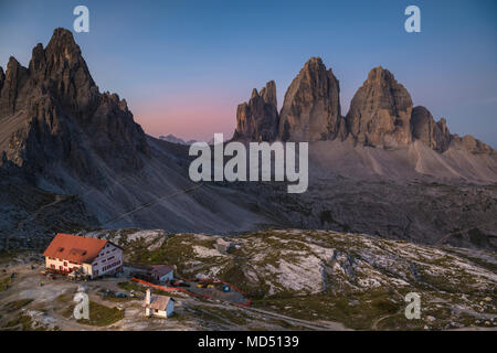 Tre Cime di Lavaredo and Dreizinnen hut at sunrise, Tre Cime Natural Park, Dolomites, South Tyrol, Italy Stock Photo