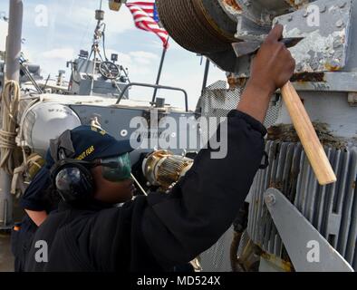 180316-N-ET513-100 MEDITERRANEAN SEA (March 16, 2018) Seaman Skyla Pearson chips paint on the Arleigh Burke-class guided-missile destroyer USS Laboon (DDG 58), March 16, 2018. Laboon, home-ported at Naval Station Norfolk, is in the U.S. 6th Fleet area of operations in support of regional allies and partners and U.S. national security interests in Europe and Africa. (U.S. Navy photo by Mass Communication Specialist 3rd Class Kallysta Castillo) Stock Photo