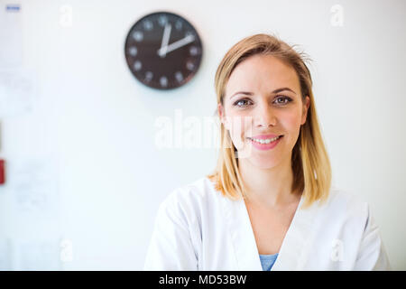Portrait of a young friendly female nurse or a doctor. Stock Photo