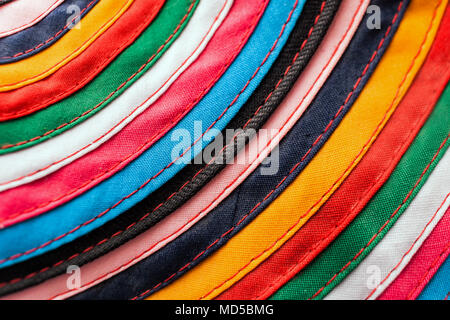 Circular handmade cloth stitched from multicolored stripes as background. Stock Photo