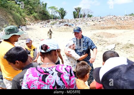 180321-N-VK873-0503 PUERTO CORTES, Honduras (March 21, 2018) Honduran locals sing 'Happy Birthday' to Chaplain Michael Vitcavich at the city's landfill during Continuing Promise 2018. U.S. Naval Forces Southern Command/U.S. 4th Fleet has deployed a force to execute Continuing Promise to conduct civil-military operations including humanitarian assistance, training engagements, and medical, dental, and veterinary support in an effort to show U.S. support and commitment to Central and South America. (U.S. Navy photo by Mass Communication Specialist 2nd Class Kayla Cosby/ Released) Stock Photo