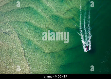 Abstract aerial photography of a boat cruising Lake Macquarie, NSW, Australia Stock Photo