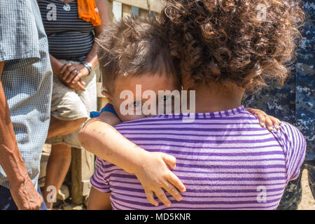 180321-A-YI894-0279 PUERTO CORTES, Honduras (March 21, 2018) A Honduran child holds onto woman during Continuing Promise 2018. U.S. Naval Forces Southern Command/U.S. 4th Fleet has deployed a force to execute Continuing Promise to conduct civil-military operations including humanitarian assistance, training engagements, and medical, dental, and veterinary support in an effort to show U.S. support and commitment to Central and South America. (U.S. Army photo by Spc. Brandon Best/ Released) Stock Photo