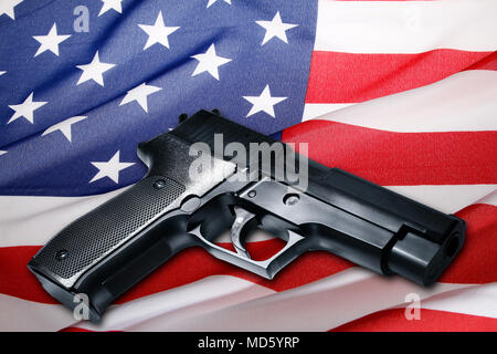 Handgun lying on American flag Stock Photo