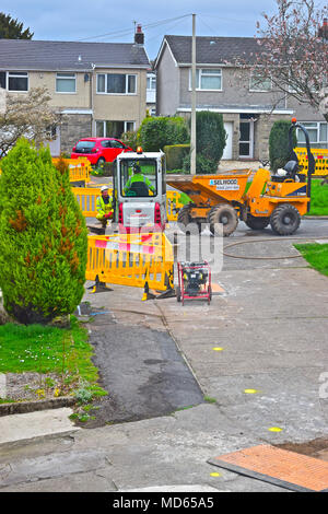 Workmen replacing old gas pipes in Rhiwbina, Cardiff. This involves digging up road and replacing equipment and pipework. Stock Photo